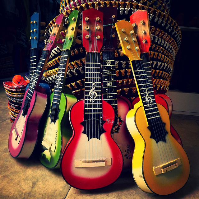 a stack of colorful guitars